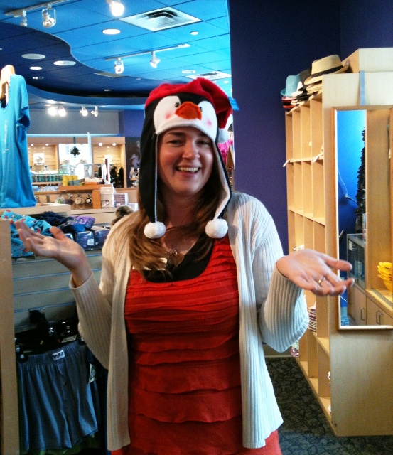Claire in gift store wearing penguin santa hat