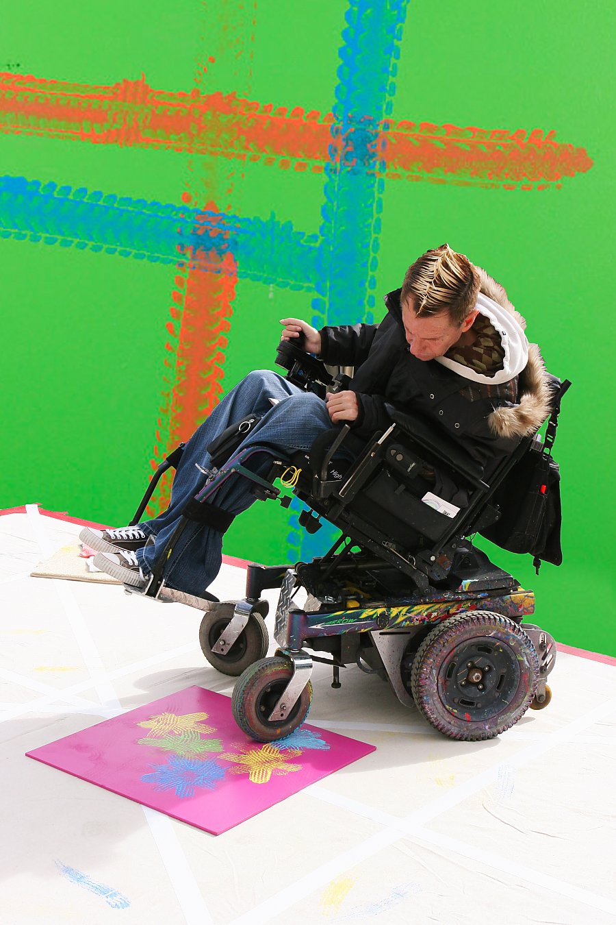 Tommy Hollenstein wheelchair artist creating art with his wheelchair