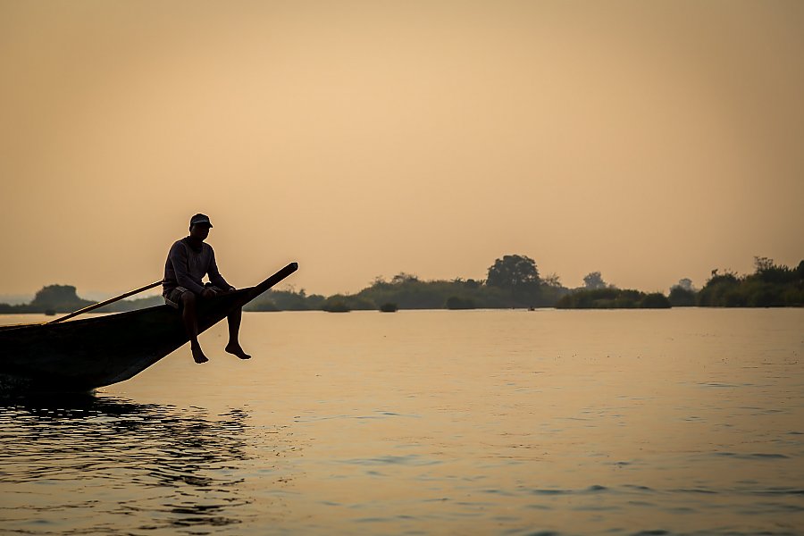 Man sitting on longtail boat.