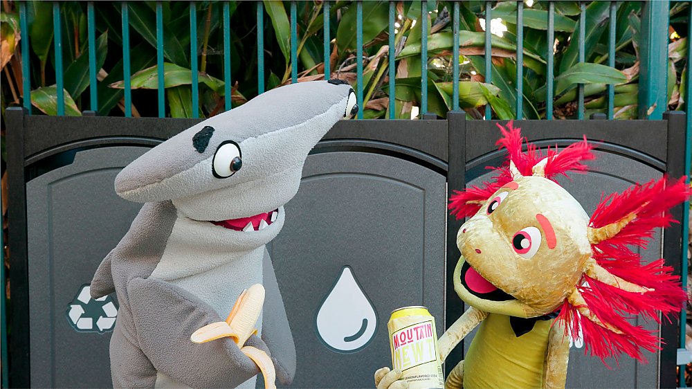 Pacific Pals characters in front of trash bins