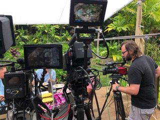 Camera operator Jack Lawson makes some adjustments on the set of the Hawaii table discussion.