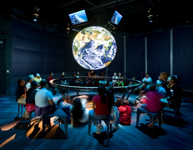 Guests surround globe Science on a Sphere
