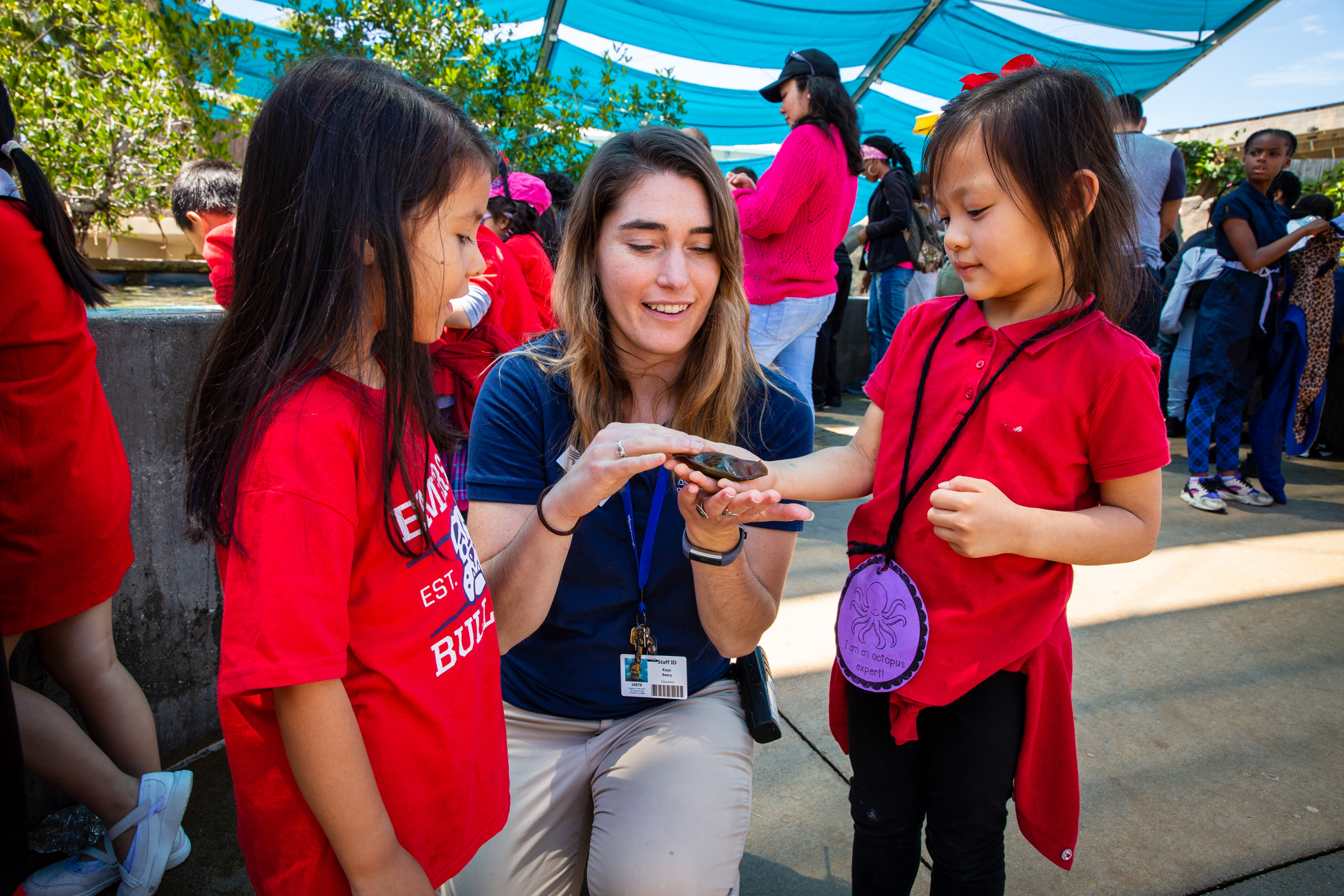 Aquarium of the Pacific volunteer educating a child visitor
