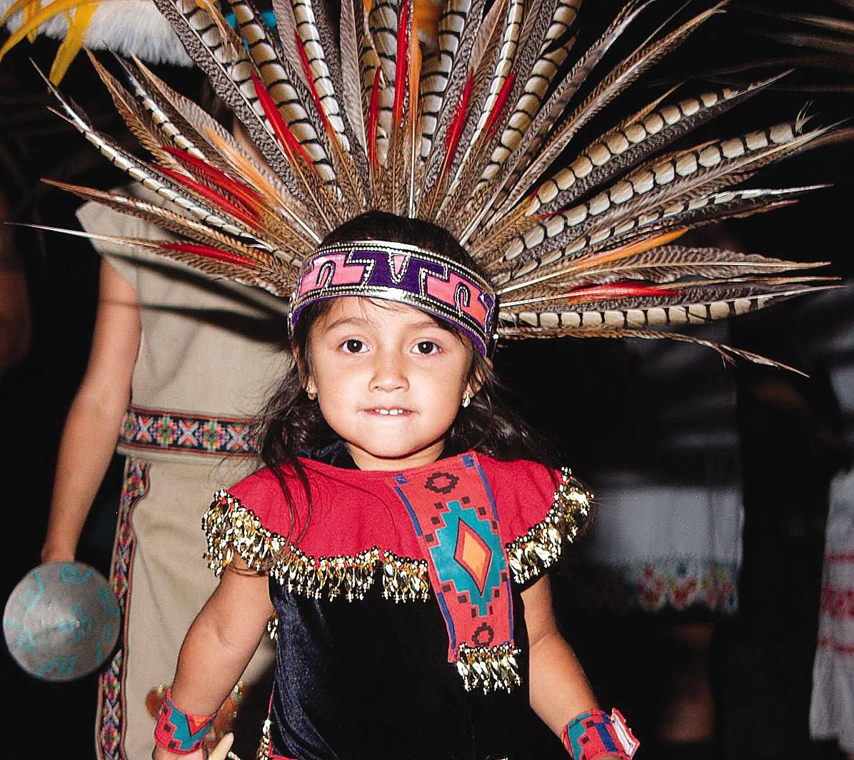 child wearing Aztec headdress and clothing