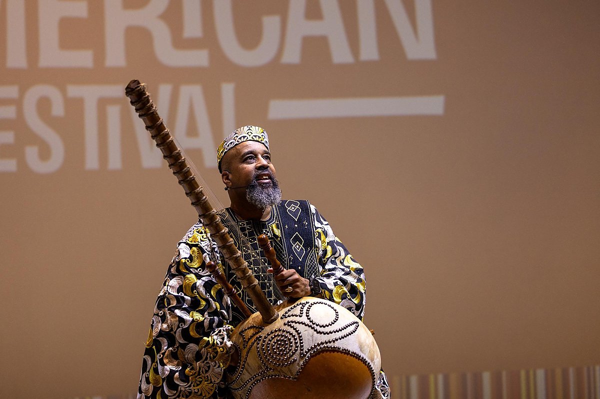 Baba the Storyteller on stage with his kora