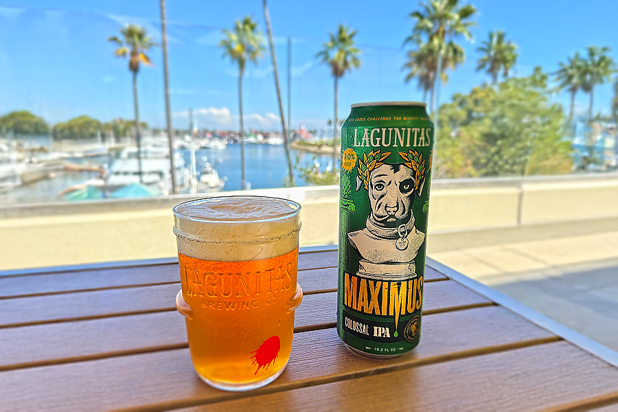 glass of beer and can of beer on a table on an outdoor veranda