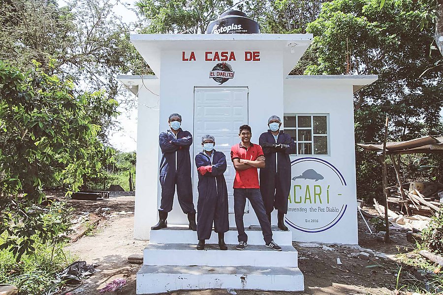 Mike Mitchell standing in front of La Casa De el Diablito with 3 other people in masks