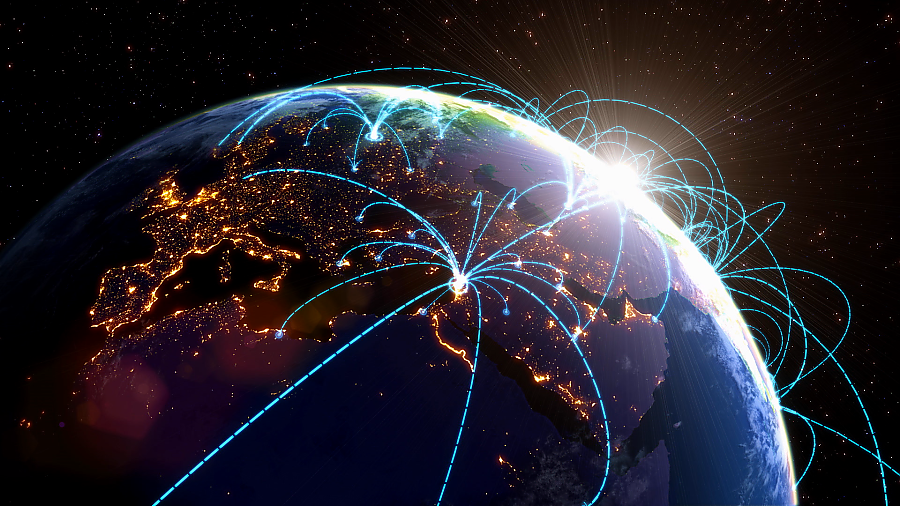 Earth as seen from space with digital lines emerging from cities out to other places.