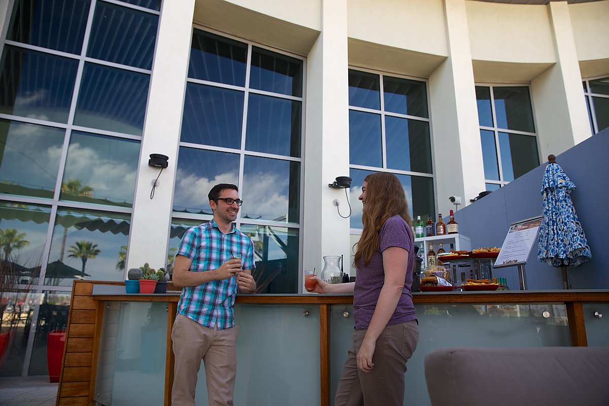 Young man and woman enjoy drinks on the Veranda