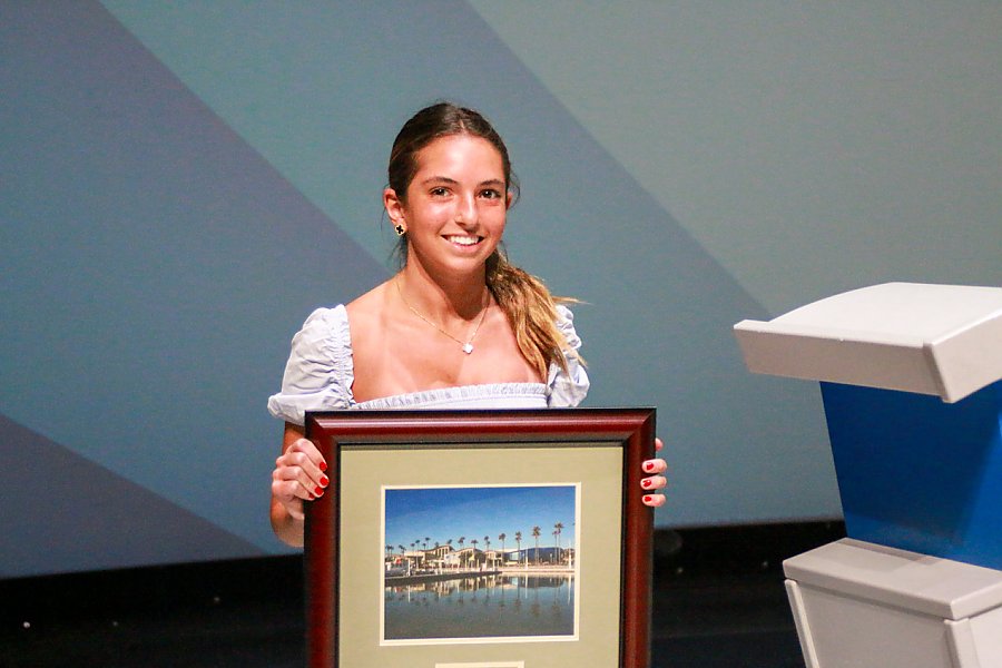Young person holding framed picture