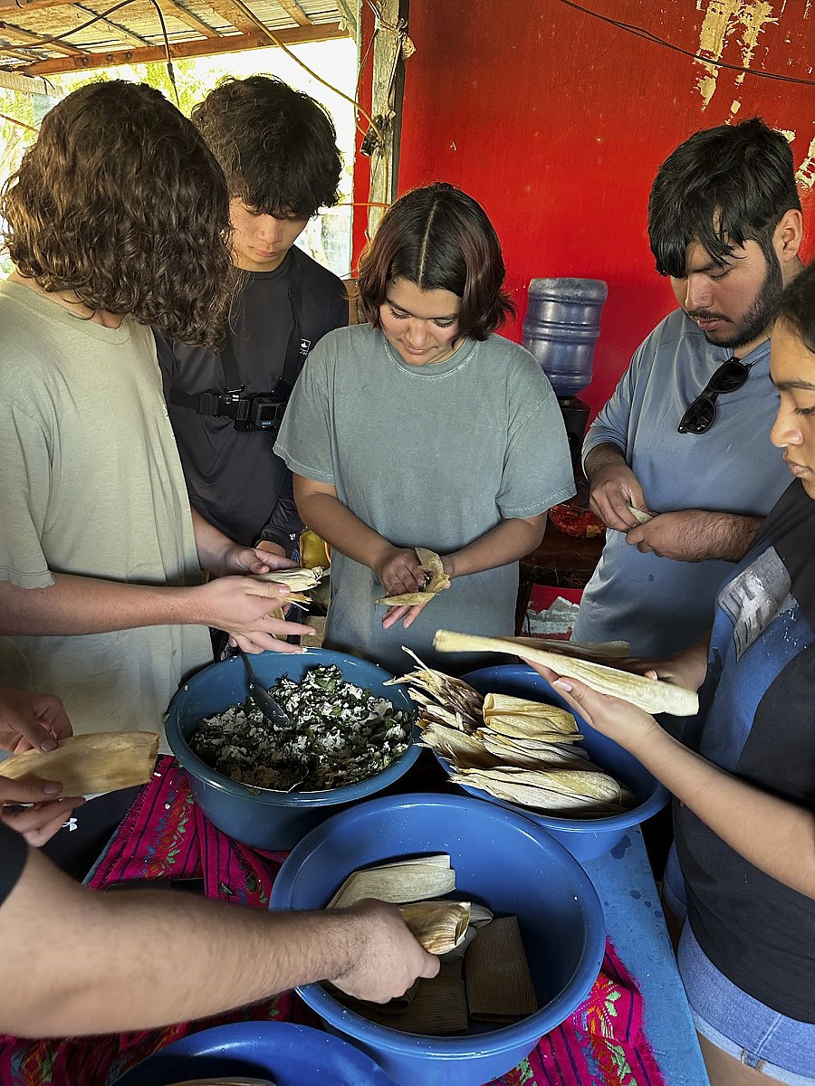 People making tamales by hand