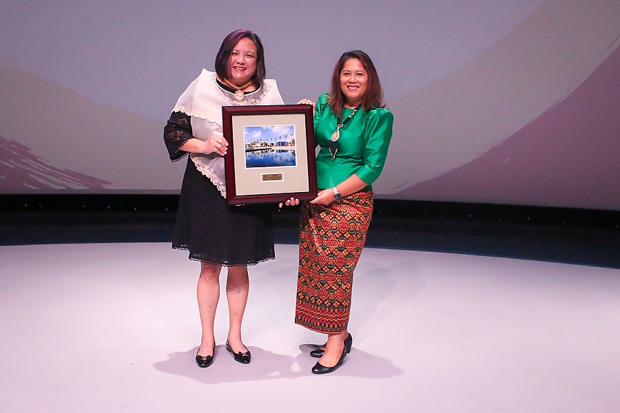 Two women holding award