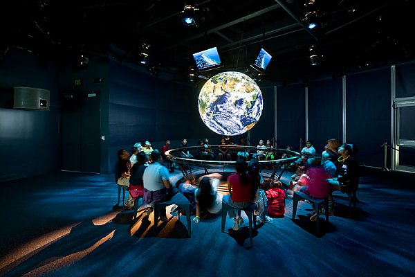 Ocean Science Center interior with people around globe