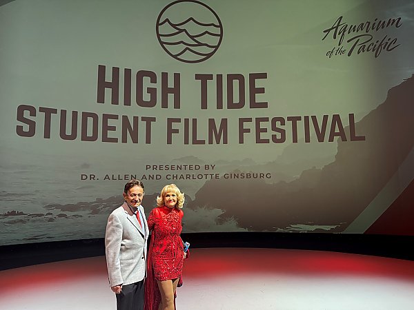 Dr. Allen and Charlotte Ginsburg in front of a screen with the text High Tide Student Film Festival