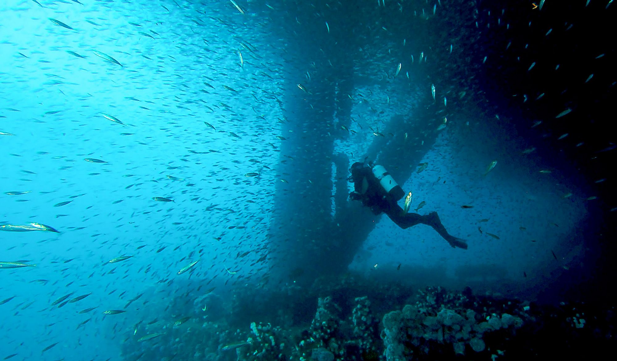 diver beneath oil rig