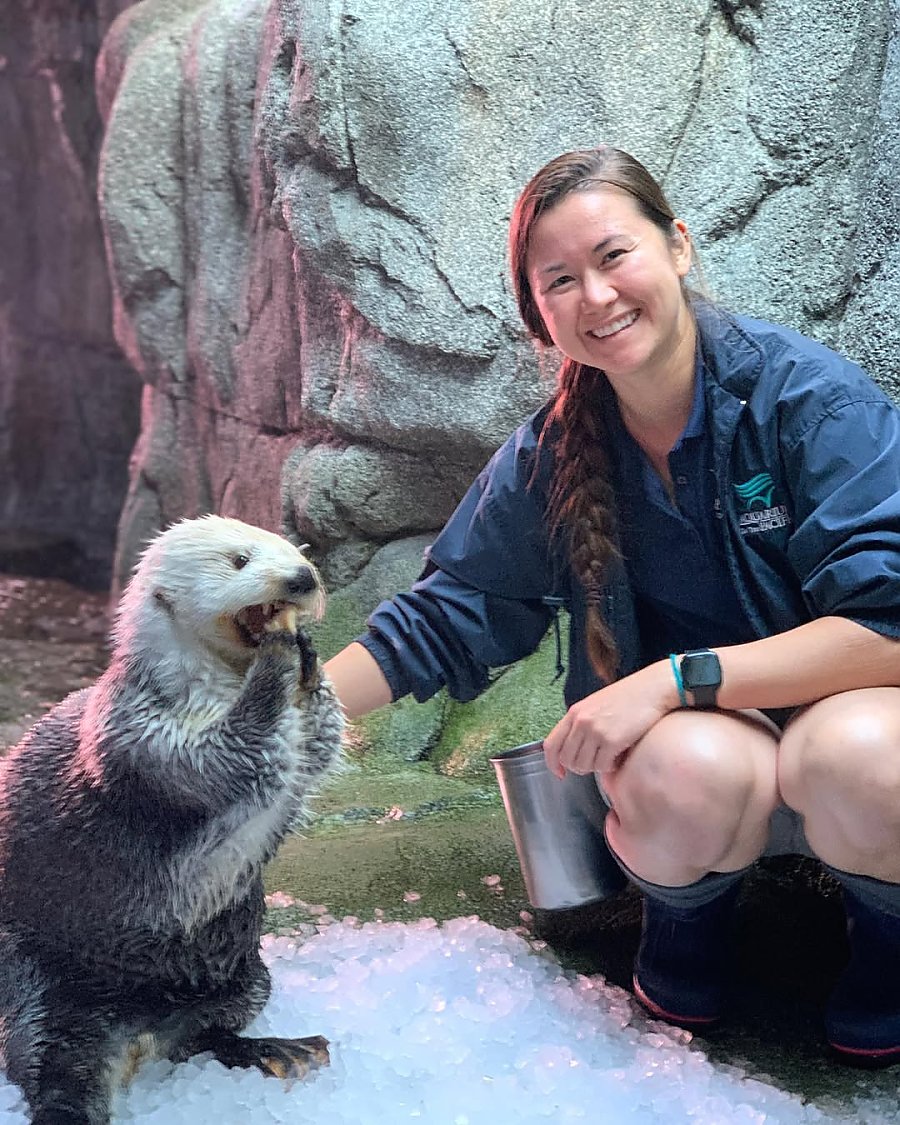 Erin Lundy with sea otter inside the Aquarium's otter habitat