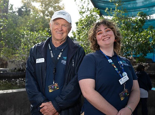 Man and woman volunteers in uniform in Shark Lagoon