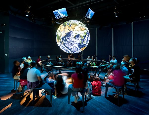 Guests surround globe Science on a Sphere