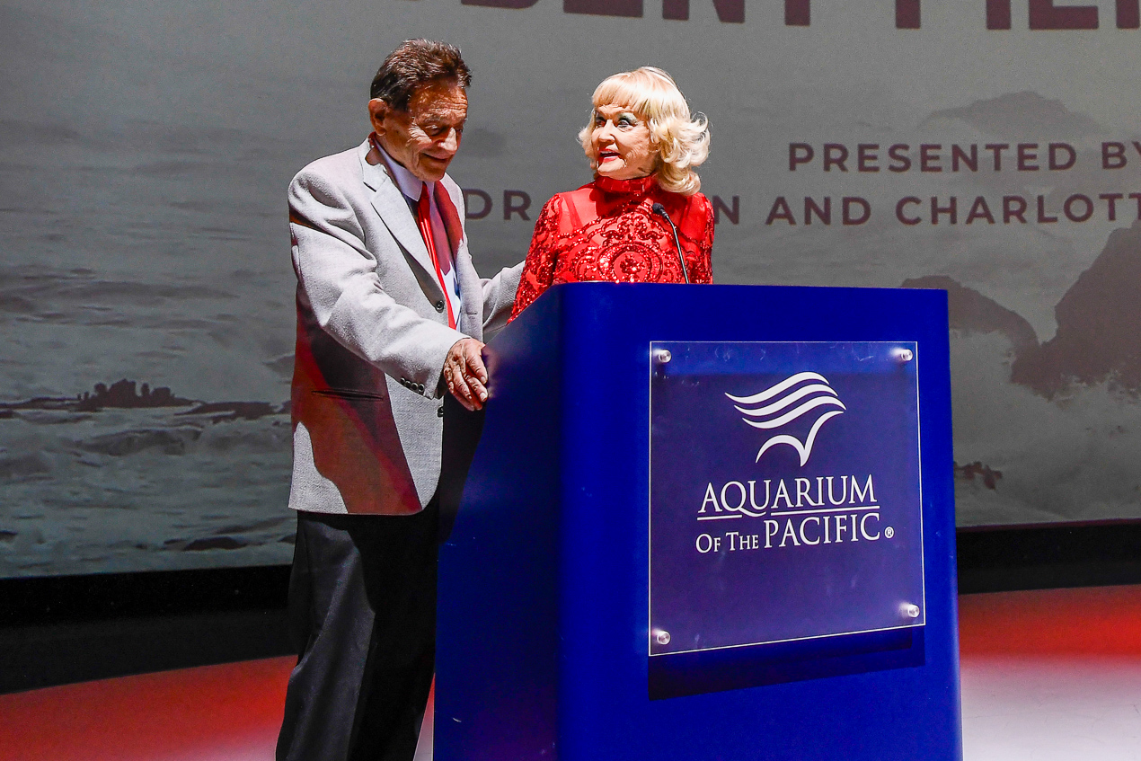 Man and woman at a podium