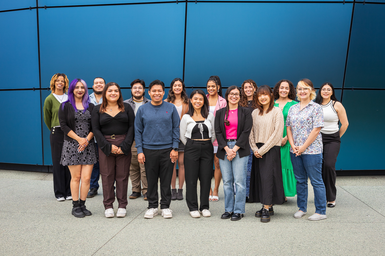 group of people in front of blue glass