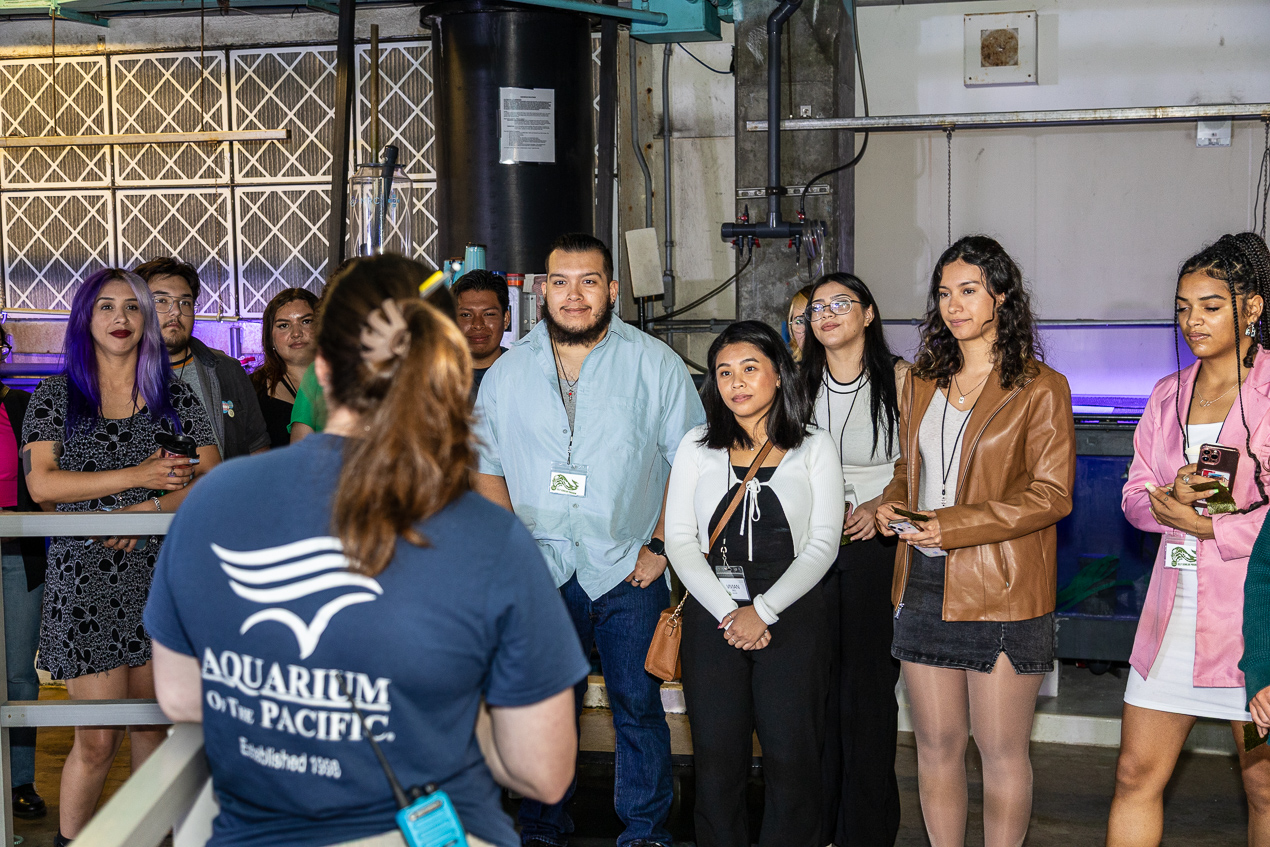 group of visitors and Aquarium staff member