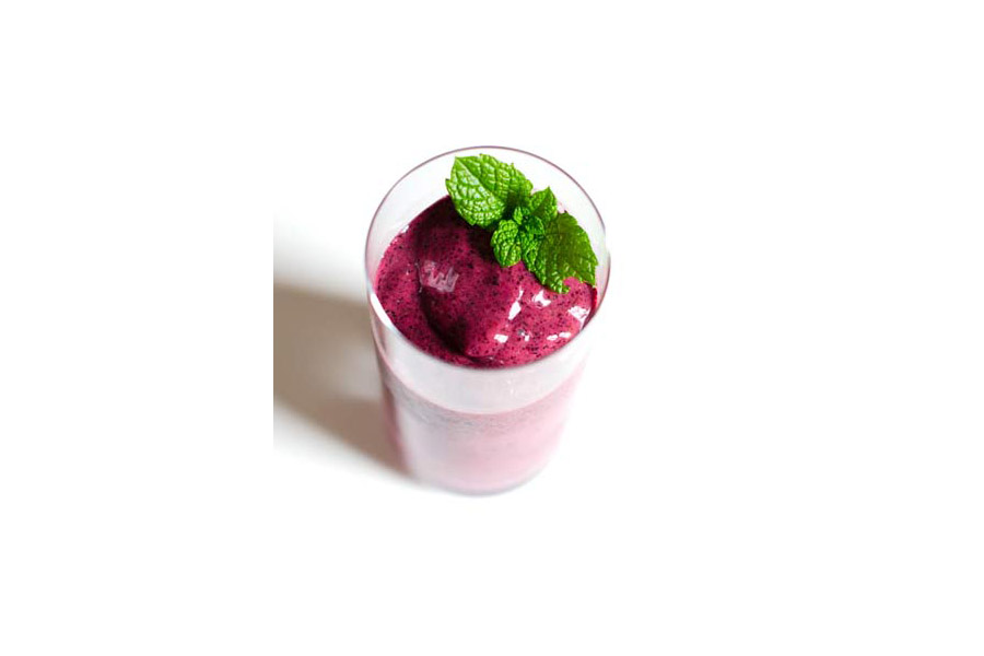 Ocean approved seaweed smoothie with blueberries and mint garnish.